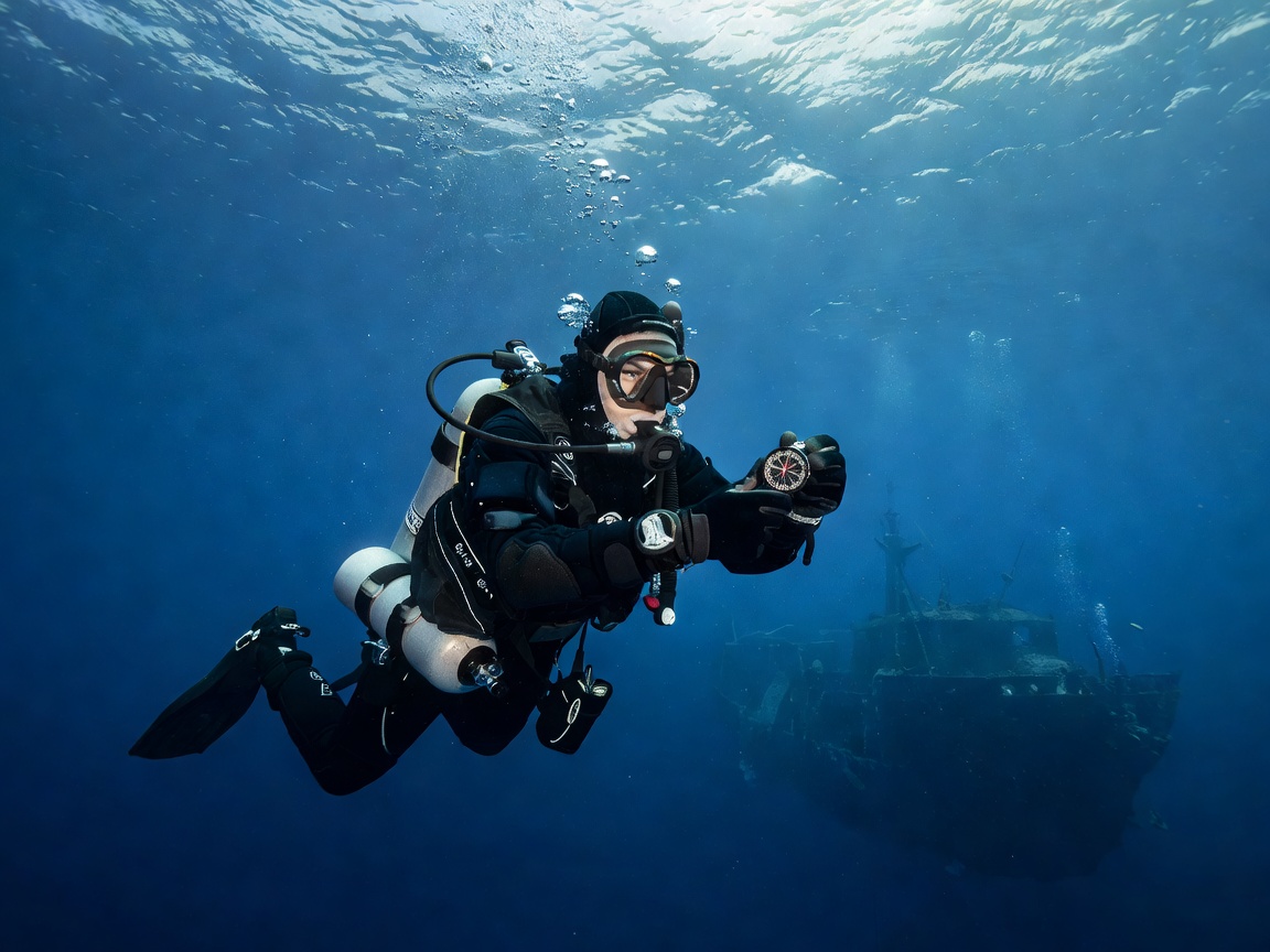 Technical diver using a compass for underwater navigation